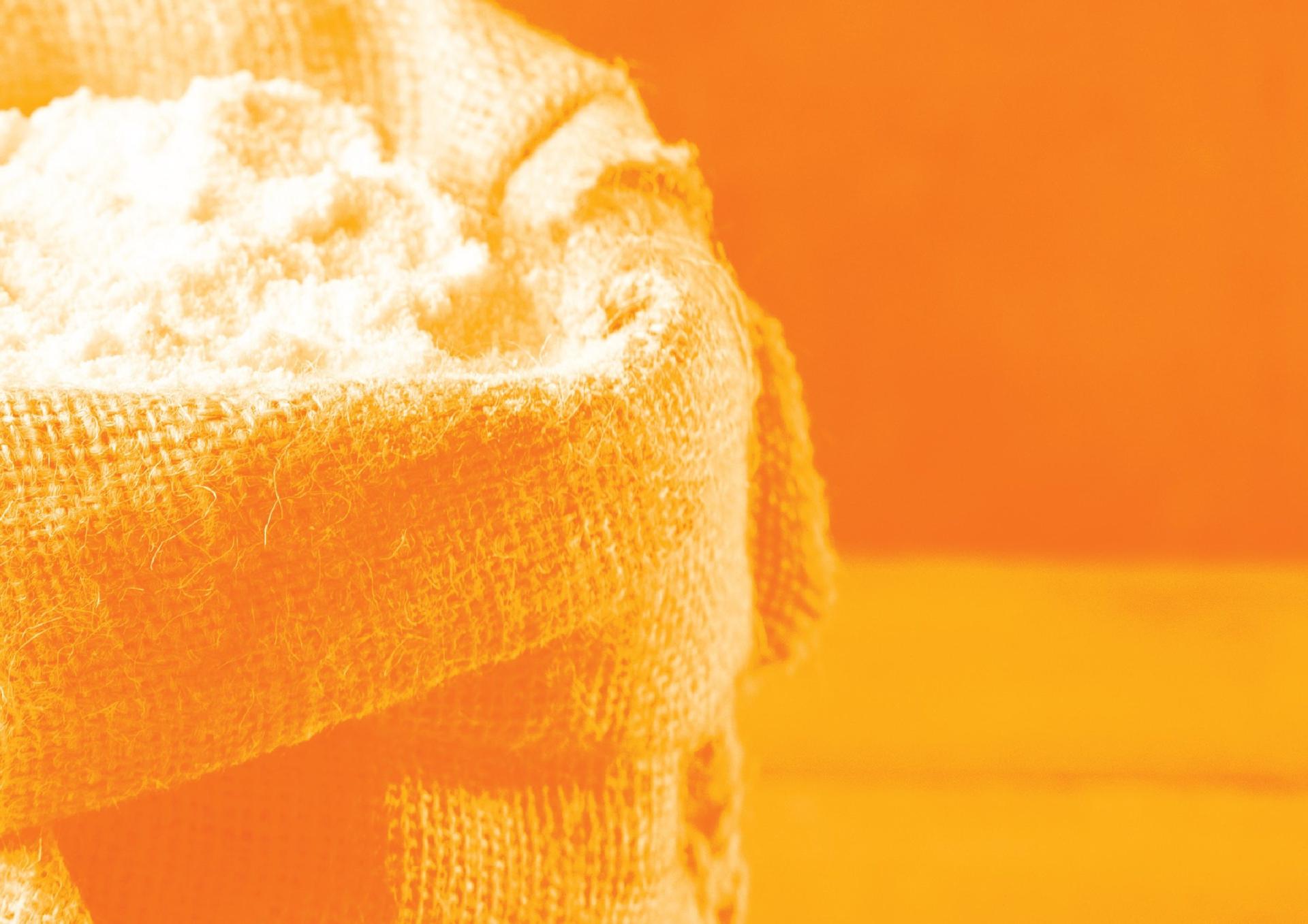 An open burlap sack of flour