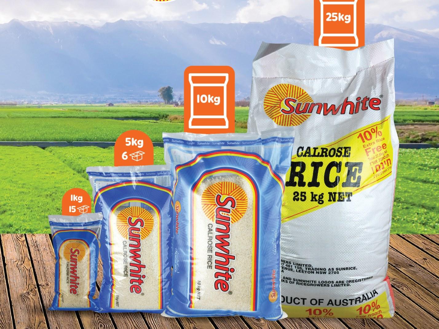 Sunwhite rice bags in several sizes in front of a green field